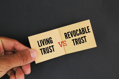 Papers with the words living trust vs revocable trust | The Law Office of Wendra J. Moran