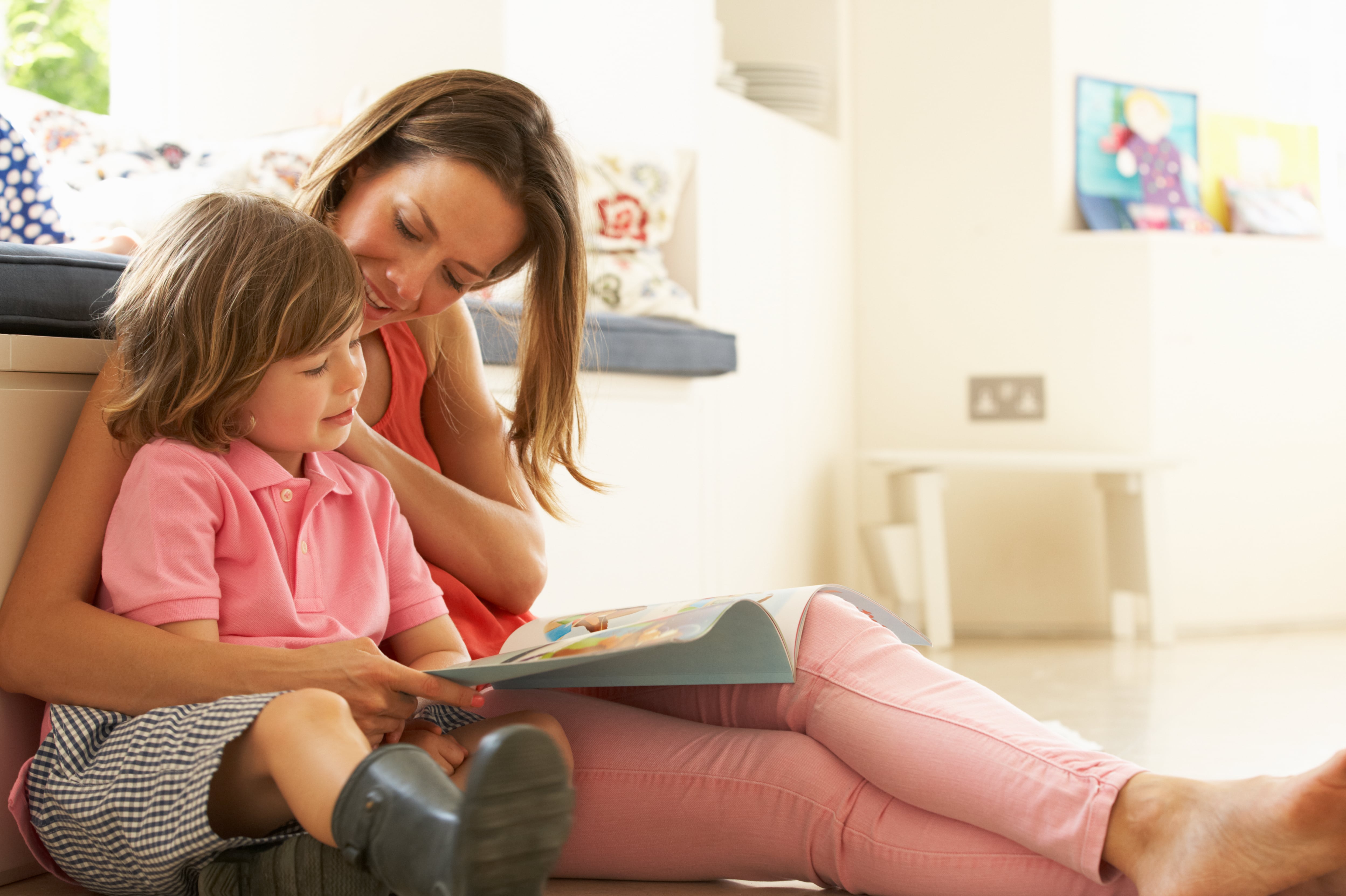 child and parent reading a book together